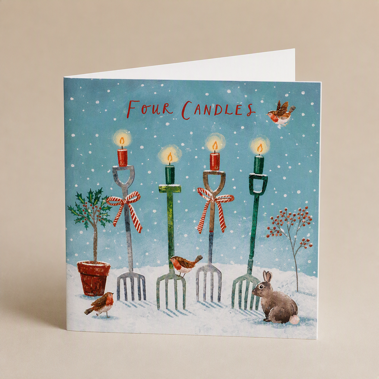 Square Christmas card featuring Four Candles text with garden forks, robins, and a rabbit in a snowy scene.