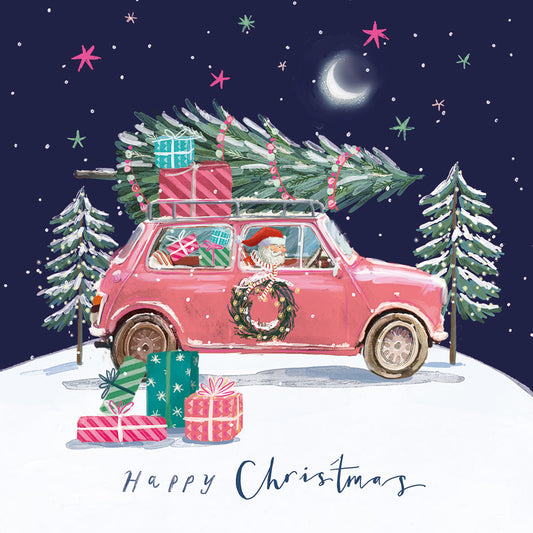 Pink car with Santa, presents, and Christmas tree in a snowy landscape on a square satin-finish charity Christmas card.
