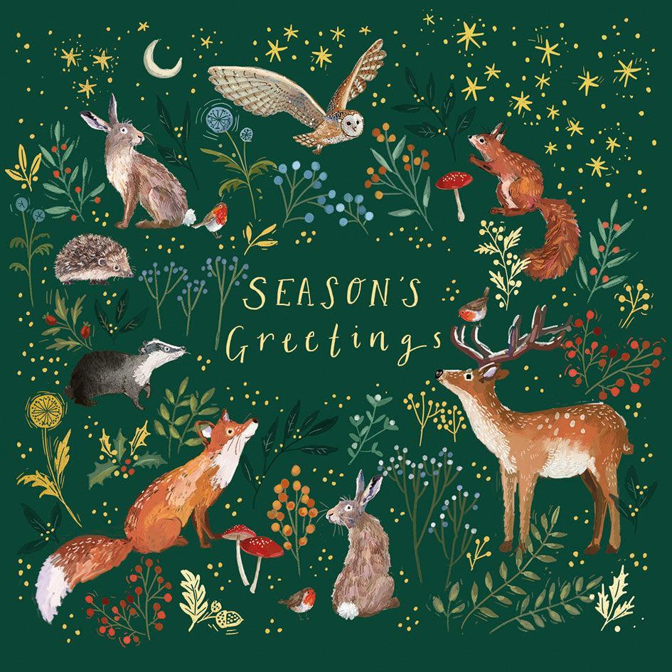 Enchanted winter woodland Christmas card with gold foil animals and foliage on a deep green satin background.