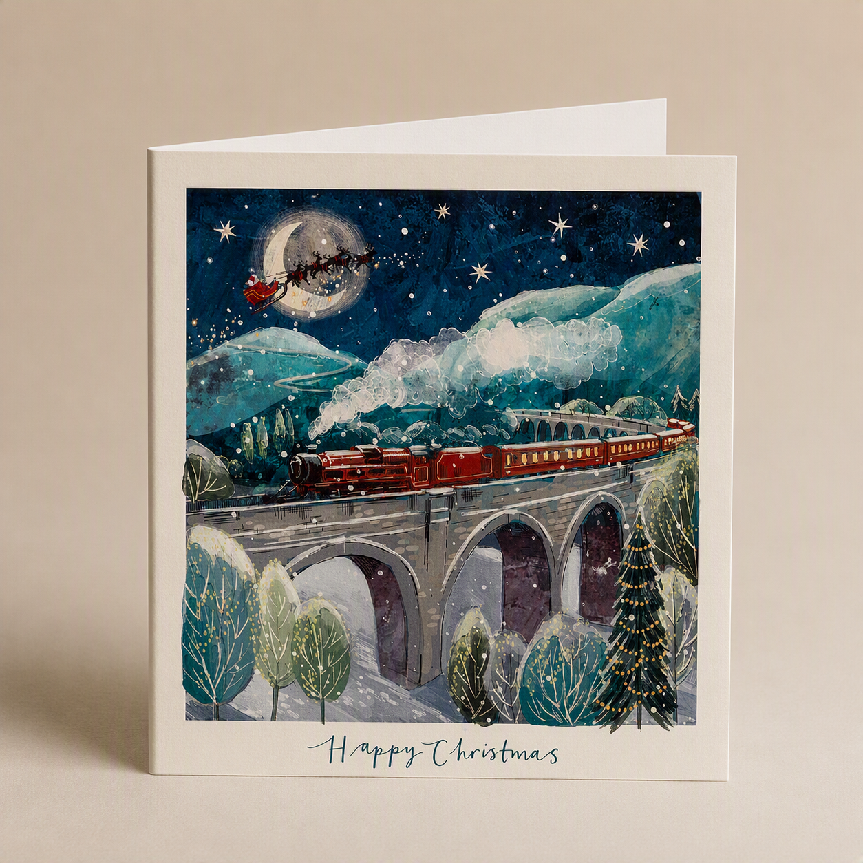 Square Christmas card featuring a red steam train on a stone viaduct under a starry night sky with Santa’s sleigh.